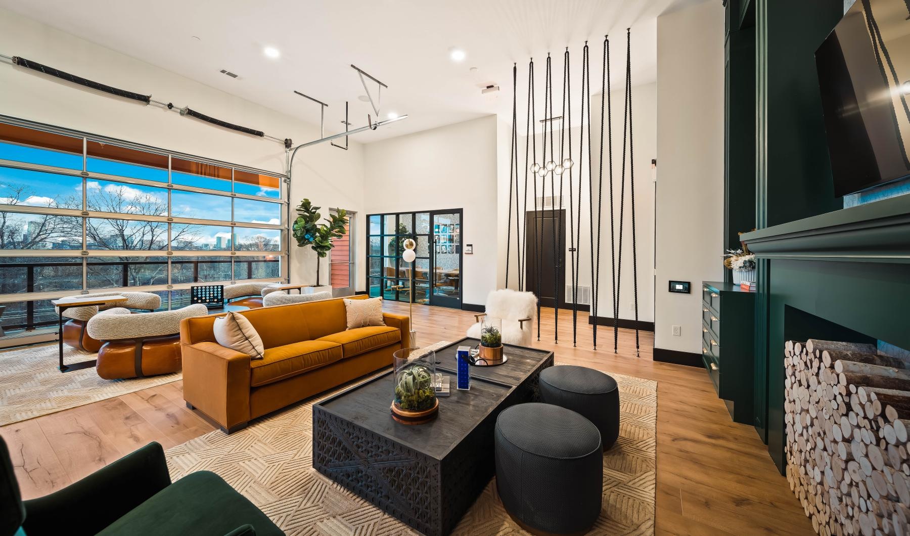 State-of-the-art amenities a clubhouse room with couches, coffee tables and a tv