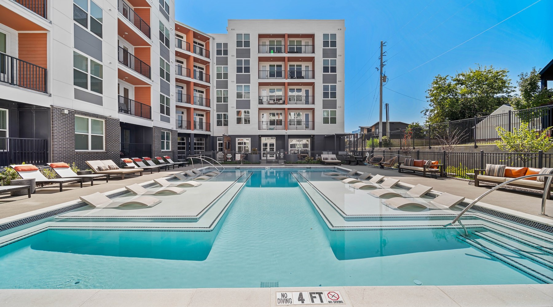 Resort-style swimming pool a swimming pool in front of a building