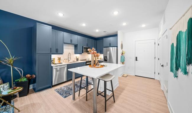 Beautiful kitchens with designer finishes a kitchen with an island and a chair
