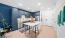 a kitchen with an island and a chair