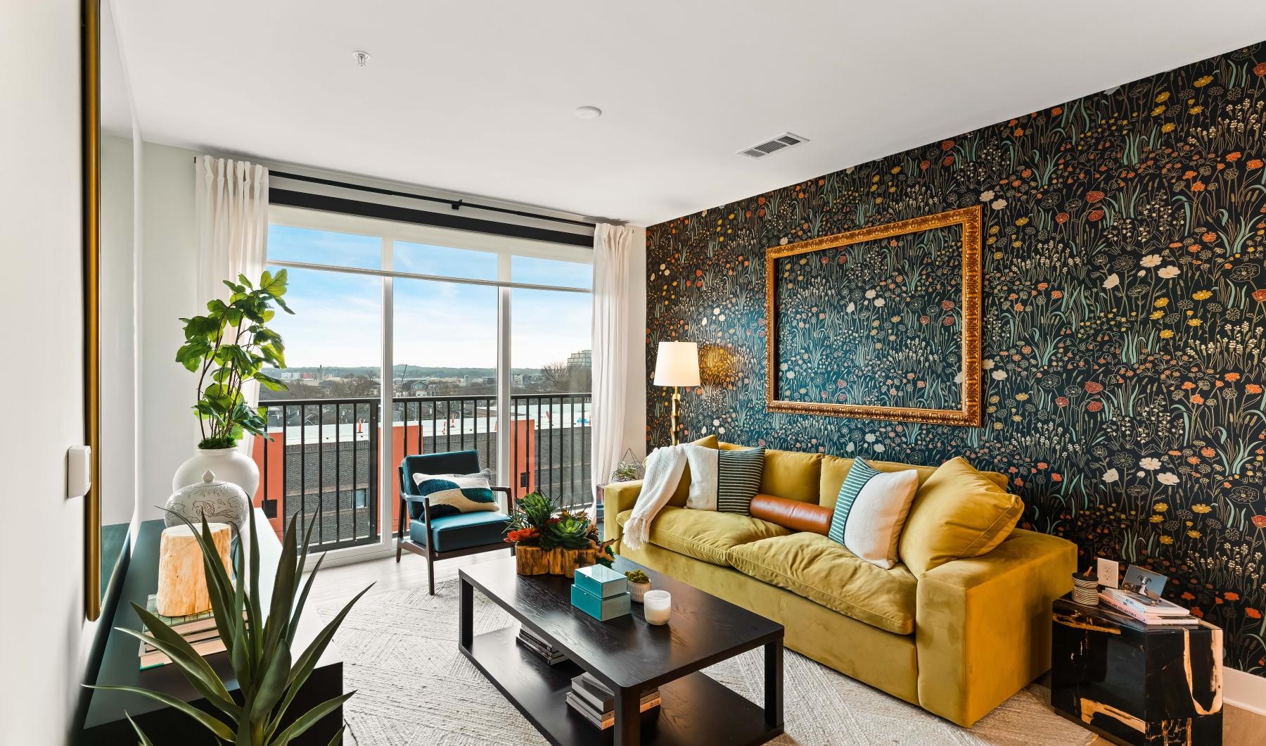 Generous living spaces with beautiful natural lighting a living room with a couch, coffee table and a  large window
