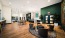 a clubhouse room with chairs, tables and wood floors