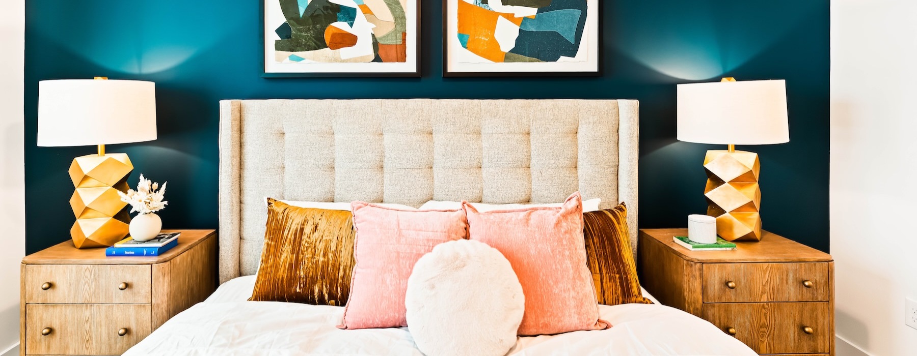 a bed with pillows and lamps