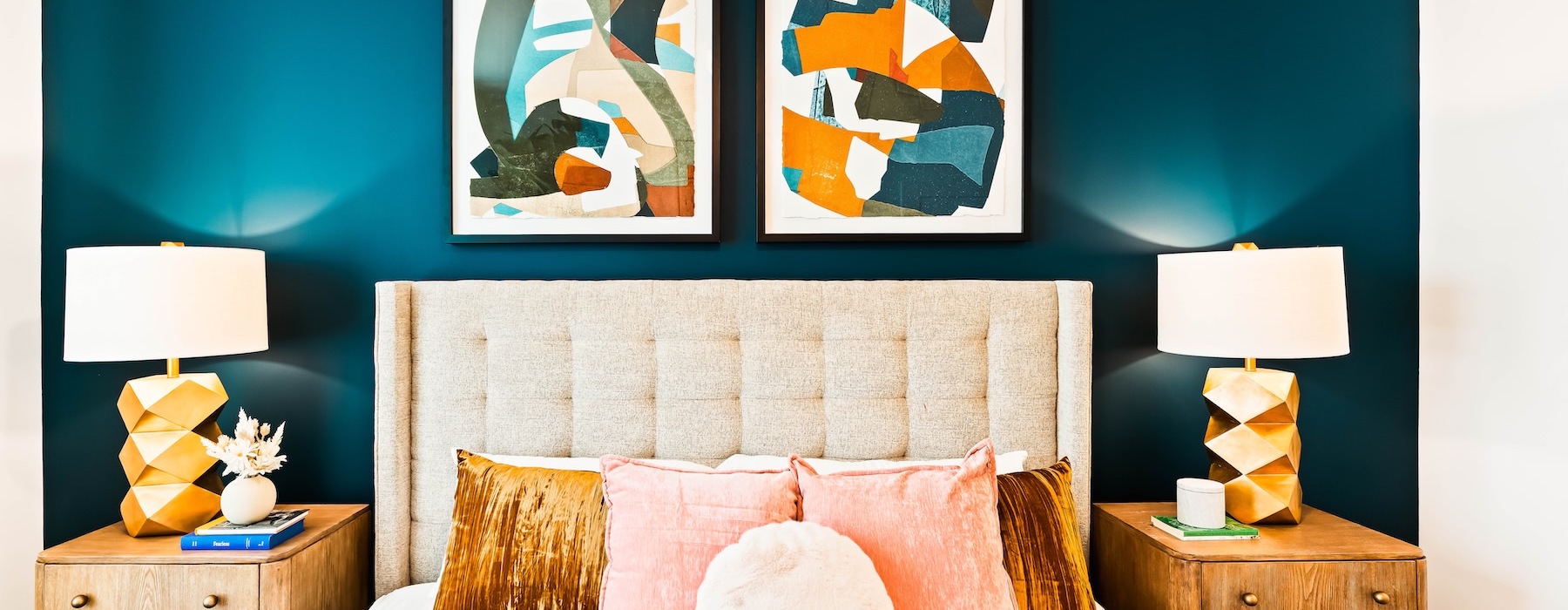 a bed with pillows and lamps