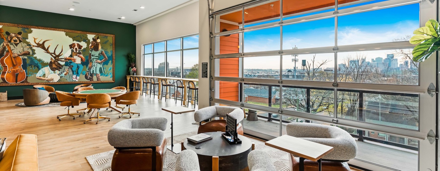 a room with a large window and a couch and chairs